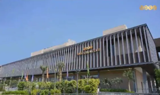 A quiet afternoon at a New Delhi metro station with wet tracks post rain, reflecting urban life.