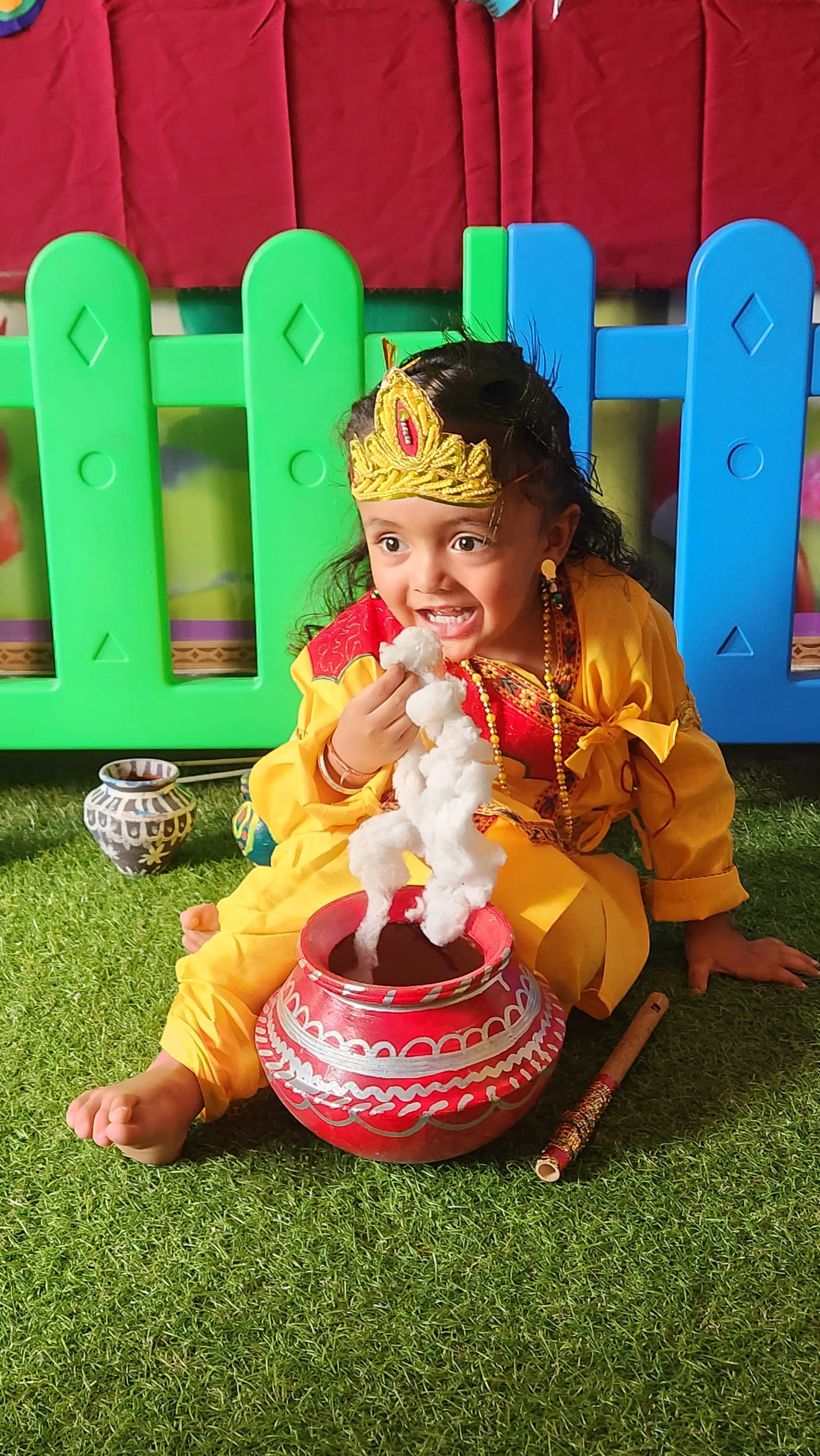 Two adults collaborating outdoors with coffee mugs, discussing work on a laptop.