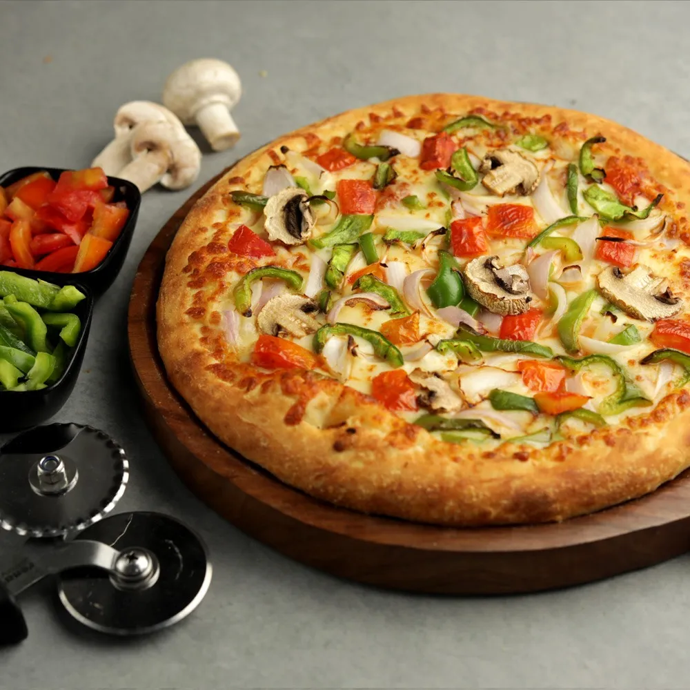 Close-up of hands shaping pizza dough on a floured surface, highlighting artisanal cooking.