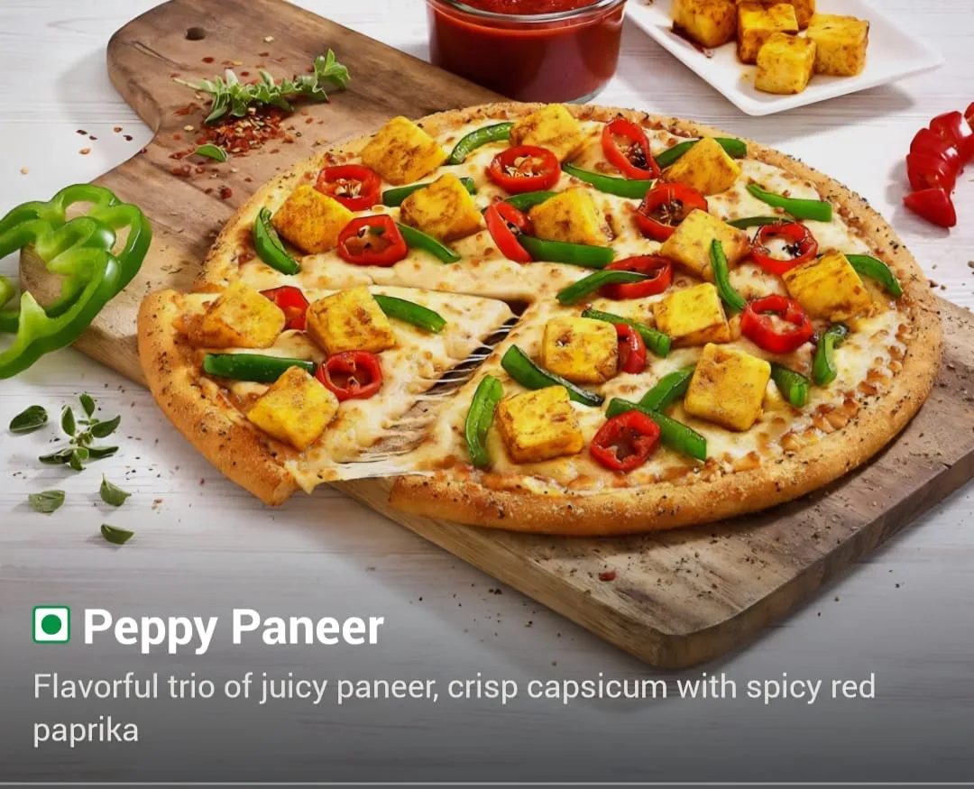 Group of young adults enjoying pizza at a café. Casual indoor setting and stylish attire.